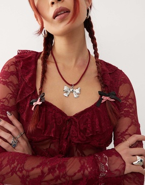 Reclaimed Vintage necklace with bow pendant on red cord