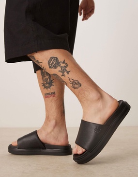 Calvin Klein Jeans embossed slide sandals in black