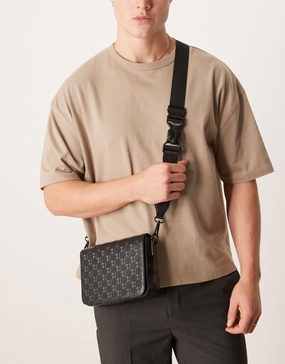 ASOS DESIGN crossbody bag with monogram emboss detail in black faux leather
