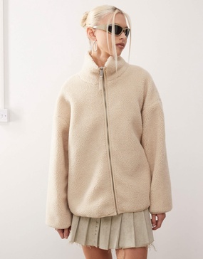 Monki long sleeve zip through fleece with contrasting trims in off white with pink floral lining