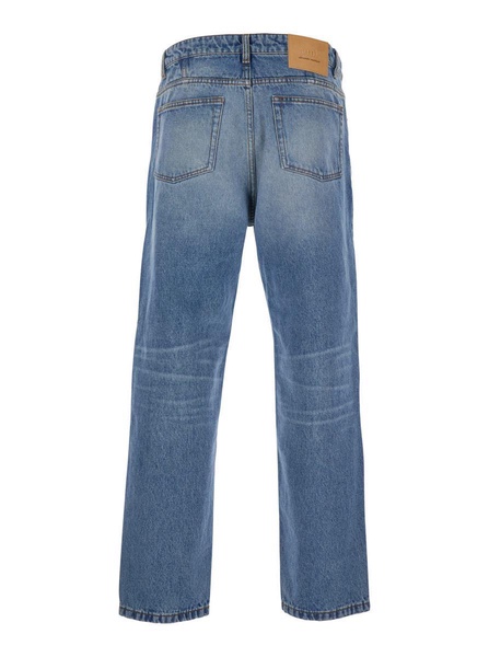 Blue Jeans With Tapered Leg And Logo Patch On The Rear In Denim Man