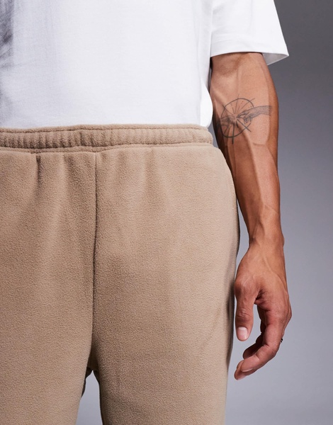 ASOS DESIGN tapered fleece sweatpants in brown