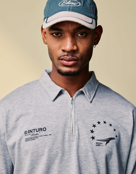 ASOS DESIGN boxy oversized zipped polo with sports graphic in gray heather rib