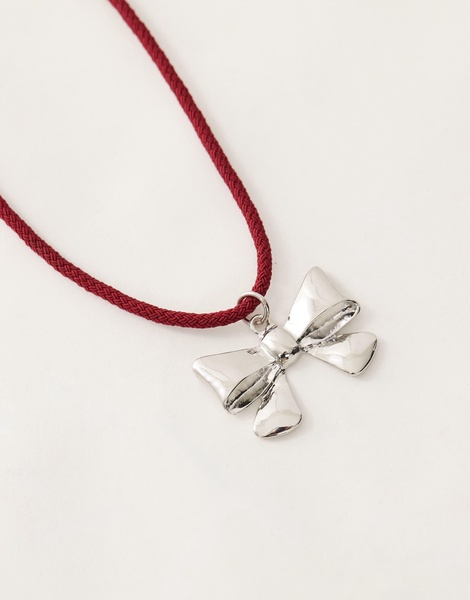 Reclaimed Vintage necklace with bow pendant on red cord
