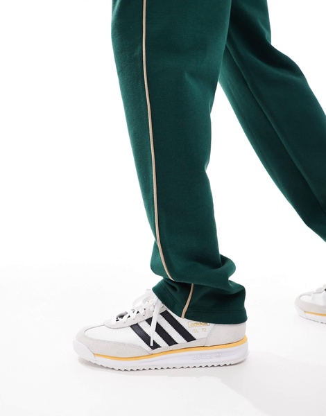ASOS DESIGN straight leg sweatpants in green with contrast yellow piping