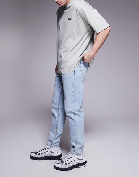 ASOS DESIGN tapered fit jeans in light wash blue