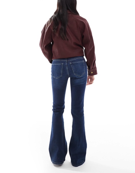Bershka Petite high rise flared jeans in dark wash