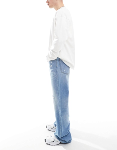 ASOS DESIGN wide flare jeans with tint & rips in mid wash blue