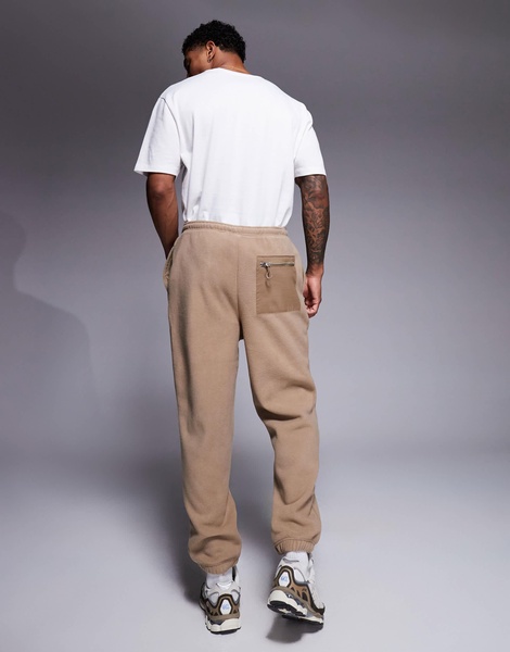 ASOS DESIGN tapered fleece sweatpants in brown