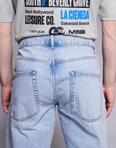 ASOS DESIGN tapered fit jeans in light wash blue