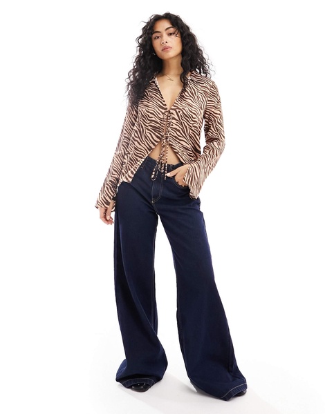 ASOS DESIGN satin tie front shirt in animal print