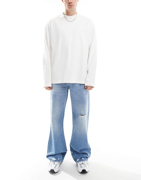 ASOS DESIGN wide flare jeans with tint & rips in mid wash blue