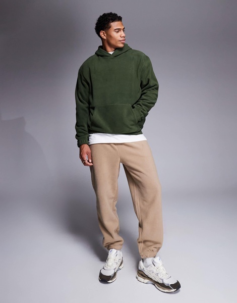 ASOS DESIGN tapered fleece sweatpants in brown