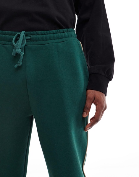 ASOS DESIGN straight leg sweatpants in green with contrast yellow piping
