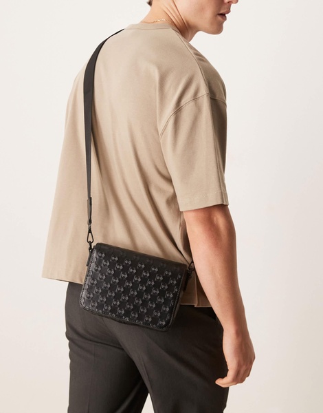 ASOS DESIGN crossbody bag with monogram emboss detail in black faux leather