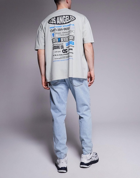 ASOS DESIGN tapered fit jeans in light wash blue
