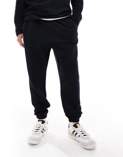 ASOS DESIGN tapered rib sweatpants in black