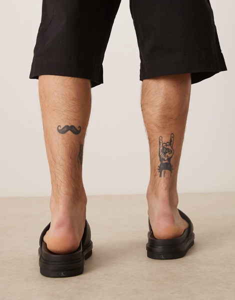 Calvin Klein Jeans embossed slide sandals in black
