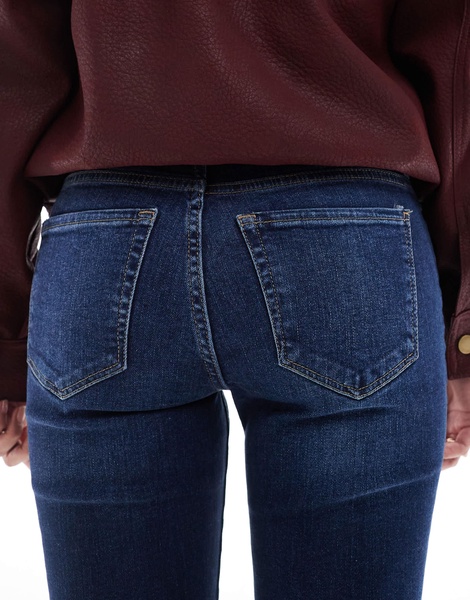 Bershka Petite high rise flared jeans in dark wash