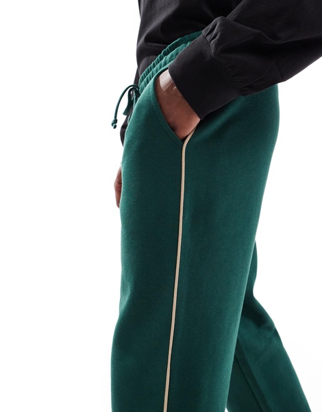 ASOS DESIGN straight leg sweatpants in green with contrast yellow piping