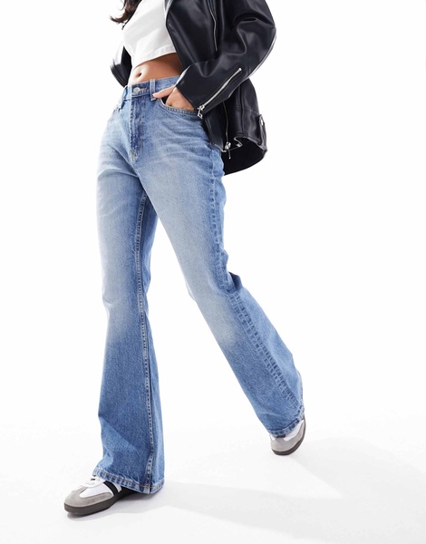 ASOS DESIGN Petite mid rise flare jeans in mid blue
