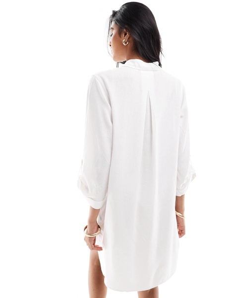 Accessorize oversized beach shirt in white