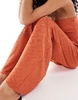 ASOS DESIGN plisse wide leg pants in rust - part of a set