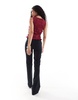 Bershka Petite flared tailored pants in black