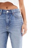 ASOS DESIGN Petite mid rise flare jeans in mid blue