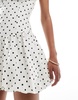 Bershka bubble hem mini dress in ecru polka dot