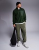 ASOS DESIGN oversized quarter zip fleece sweatshirt in dark green with chest pocket