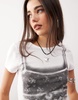Monki shrunken fit baby tee with bra graphic in white