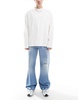 ASOS DESIGN wide flare jeans with tint & rips in mid wash blue