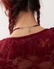 Reclaimed Vintage necklace with bow pendant on red cord