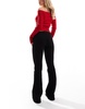 Bershka Petite high waisted flared jeans in black
