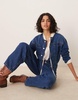 ASOS DESIGN premium collarless denim jumpsuit in midwash blue
