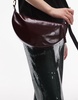 AllSaints half moon leather crossbody bag in burgundy
