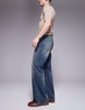 ASOS DESIGN wide flare jeans with tint in mid wash blue