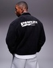 ASOS DESIGN boxy oversized fleece quarter zip sweatshirt with contrast binding and print in black