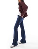 Bershka Petite high rise flared jeans in dark wash