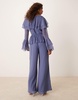ASOS DESIGN exaggerated ruffle sleeve jumpsuit with cut out waist in blue