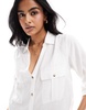 Accessorize oversized beach shirt in white