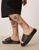 Calvin Klein Jeans embossed slide sandals in black