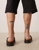 Calvin Klein Jeans embossed slide sandals in black