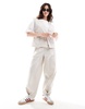 ASOS DESIGN tapered pants with tab hem detail in stone - part of a set