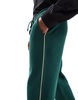 ASOS DESIGN straight leg sweatpants in green with contrast yellow piping