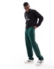 ASOS DESIGN straight leg sweatpants in green with contrast yellow piping