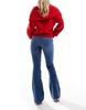 Bershka Petite high rise flared jeans in light wash blue