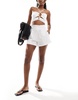 ASOS DESIGN floral embroidery flippy shorts in white