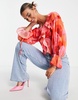 ASOS DESIGN ruffle front blouse with tie in blurred rose print